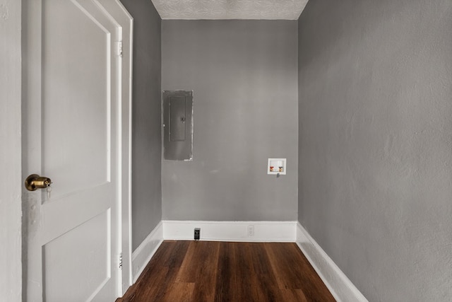 laundry room featuring laundry area, electric panel, baseboards, dark wood finished floors, and hookup for a washing machine