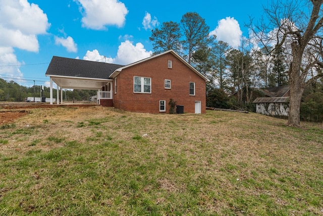 view of property exterior with brick siding and a yard