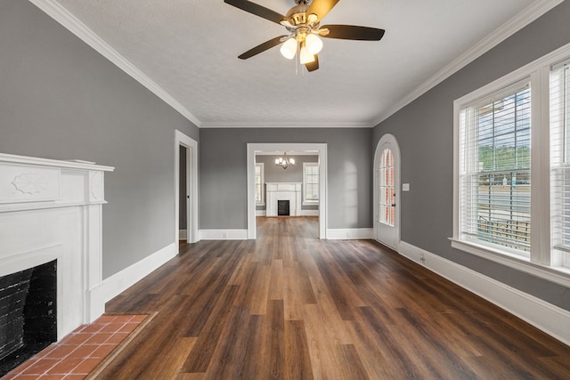 unfurnished living room with a textured ceiling, a fireplace, baseboards, ornamental molding, and dark wood finished floors