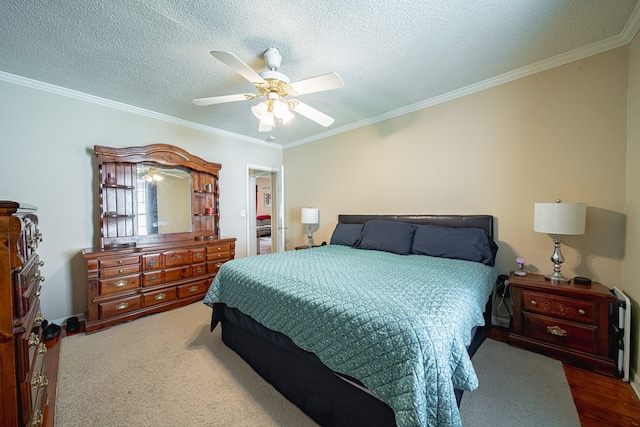 bedroom with crown molding, a textured ceiling, ceiling fan, and wood finished floors