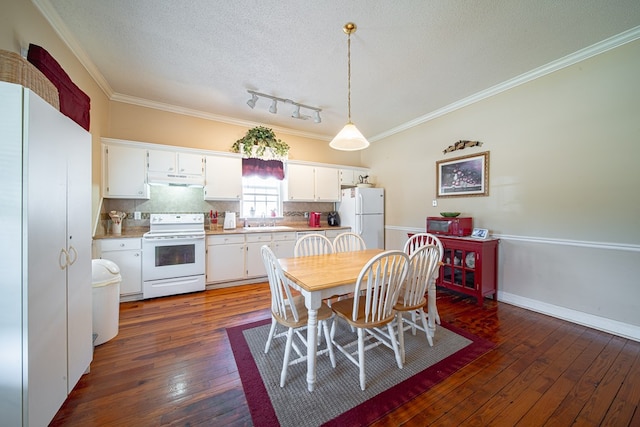 dining room with crown molding, dark wood-style flooring, a textured ceiling, and baseboards
