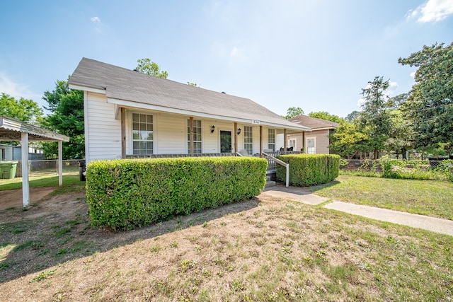 bungalow-style house featuring fence, covered porch, and a front yard