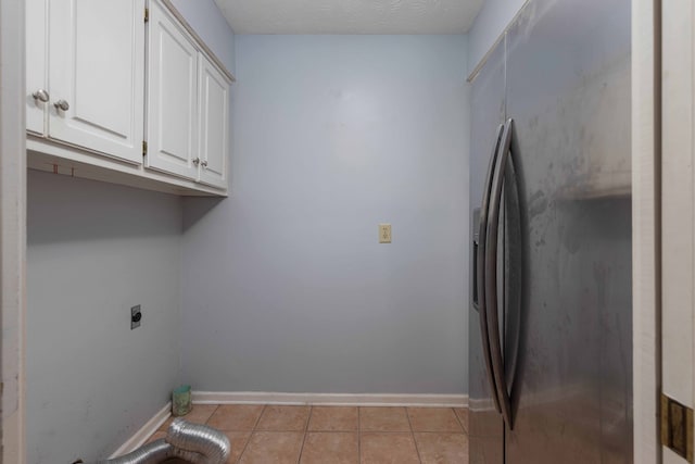 767 River Oaks Ct, Columbus, GA 31904 - laundry room featuring electric dryer hookup, cabinet space, and light tile patterned flooring