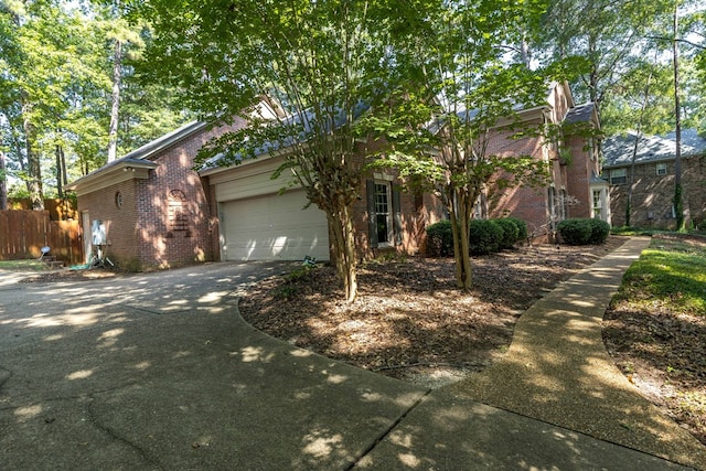 767 River Oaks Ct, Columbus, GA 31904 - obstructed view of property featuring brick siding, concrete driveway, and a garage