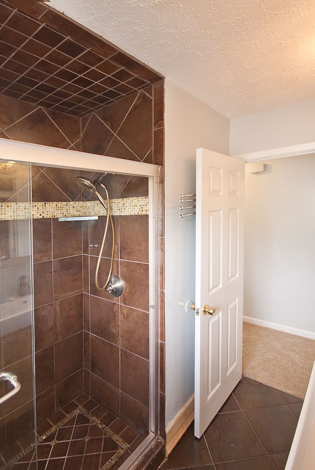 5622 Pollman St, Columbus, GA 31907 - bathroom with a stall shower, tile patterned flooring, and a textured ceiling