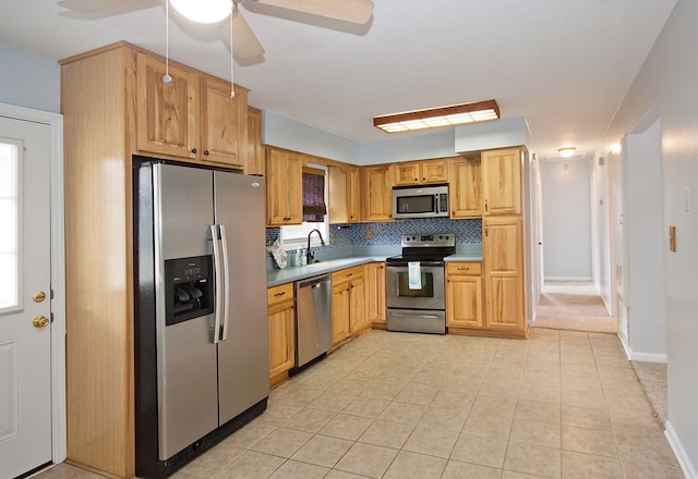 5622 Pollman St, Columbus, GA 31907 - kitchen featuring appliances with stainless steel finishes, a ceiling fan, decorative backsplash, light tile patterned flooring, and light countertops