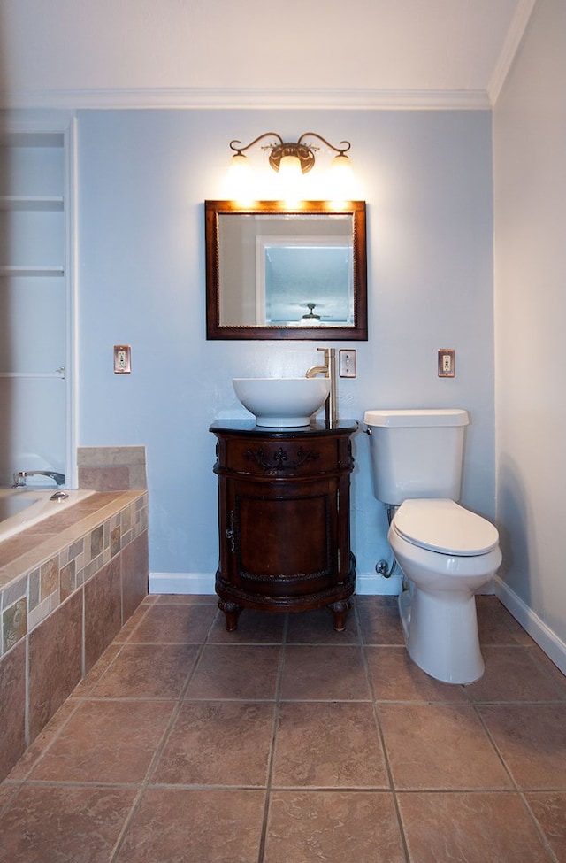 5622 Pollman St, Columbus, GA 31907 - bathroom with crown molding, vanity, tiled bath, and tile patterned flooring