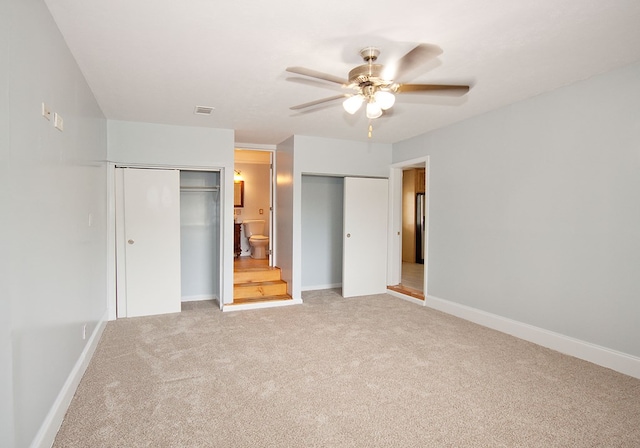 5622 Pollman St, Columbus, GA 31907 - unfurnished bedroom featuring multiple closets, light carpet, and a ceiling fan