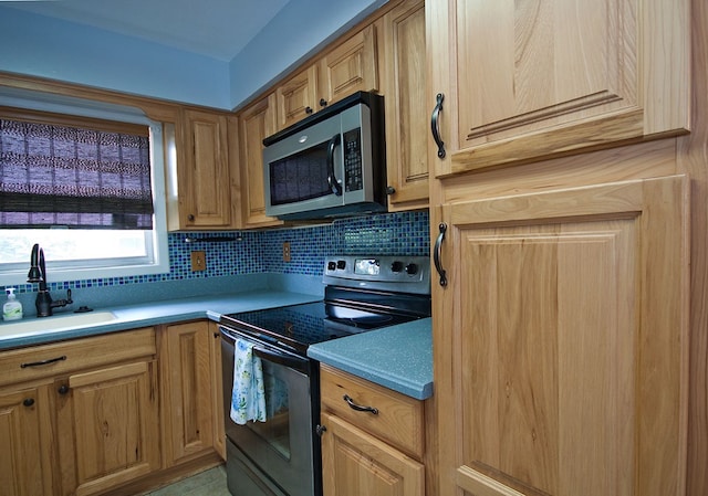 5622 Pollman St, Columbus, GA 31907 - kitchen featuring range with electric stovetop, stainless steel microwave, tasteful backsplash, and light countertops