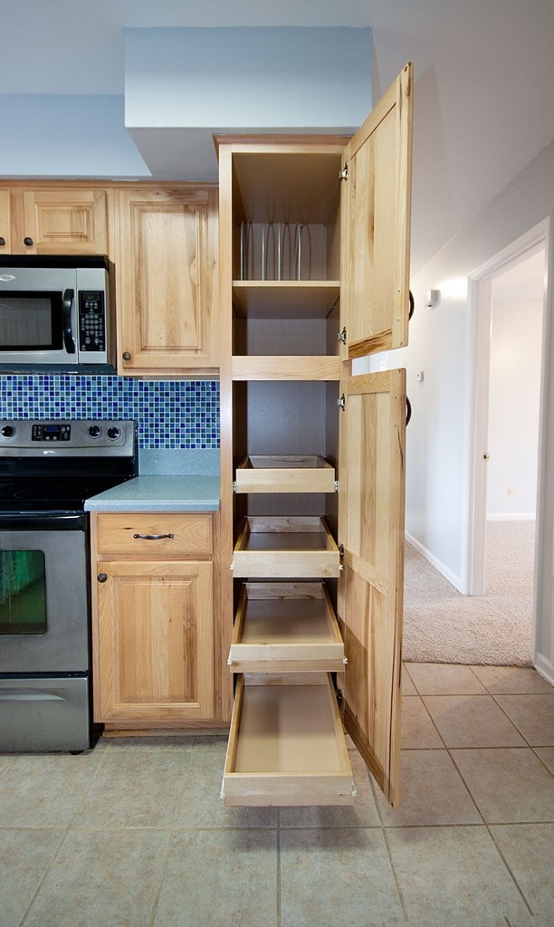 5622 Pollman St, Columbus, GA 31907 - kitchen featuring appliances with stainless steel finishes, light brown cabinets, light tile patterned flooring, decorative backsplash, and light carpet