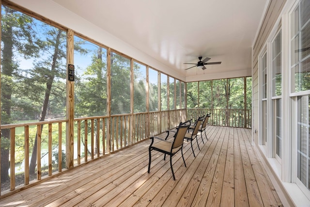 unfurnished sunroom with ceiling fan