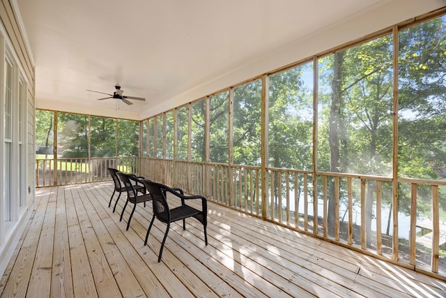 unfurnished sunroom featuring ceiling fan