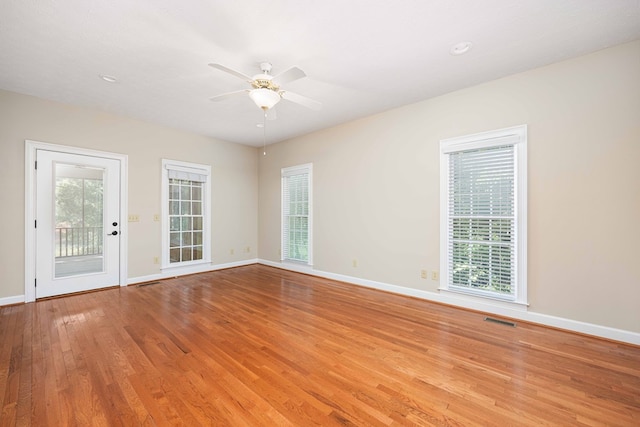 spare room with ceiling fan, light hardwood / wood-style floors, and a textured ceiling