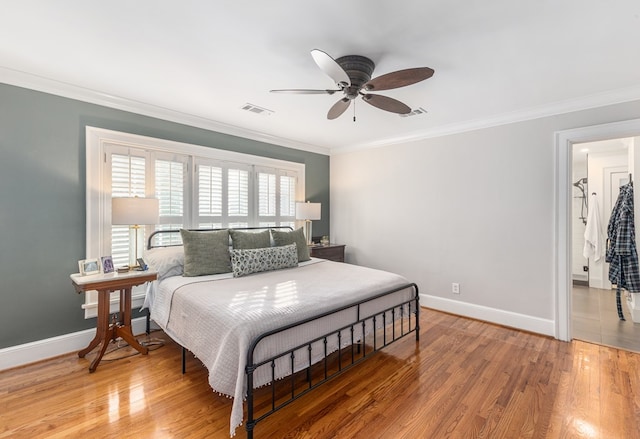 bedroom featuring visible vents, wood finished floors, and ornamental molding