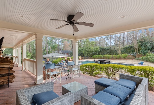 view of patio / terrace featuring ceiling fan, an outdoor hangout area, fence, and an outdoor pool