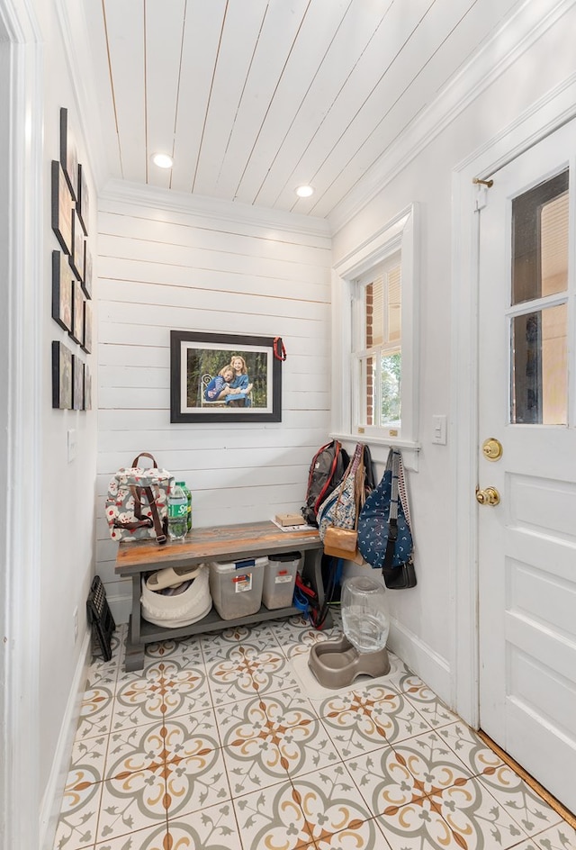 mudroom with ornamental molding, tile patterned flooring, and baseboards