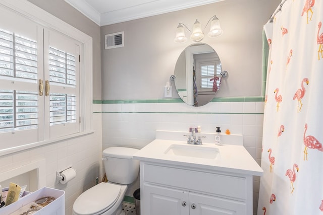 full bath with a wainscoted wall, crown molding, visible vents, toilet, and vanity