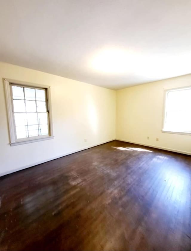 empty room featuring dark wood finished floors