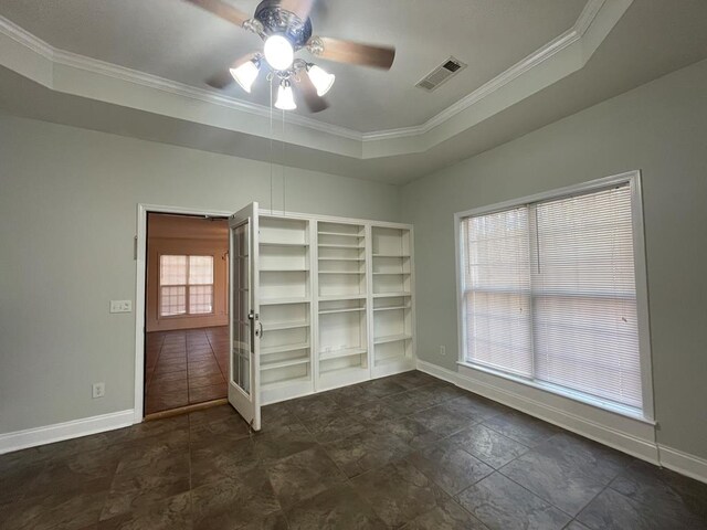 unfurnished bedroom featuring visible vents, light carpet, ensuite bathroom, baseboards, and ceiling fan