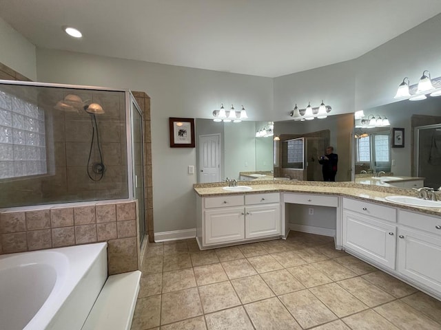 full bathroom with a garden tub, a stall shower, tile patterned floors, and a sink