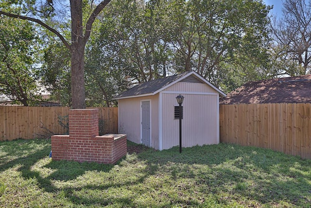 view of shed with a fenced backyard