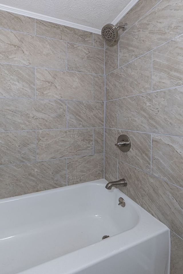 full bathroom with a textured ceiling and shower / tub combination