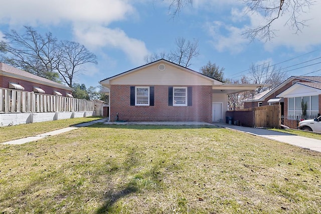 view of home's exterior with an attached carport, brick siding, fence, concrete driveway, and a lawn