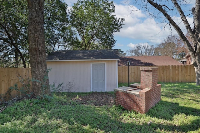 view of outdoor structure with a fenced backyard and an outdoor structure