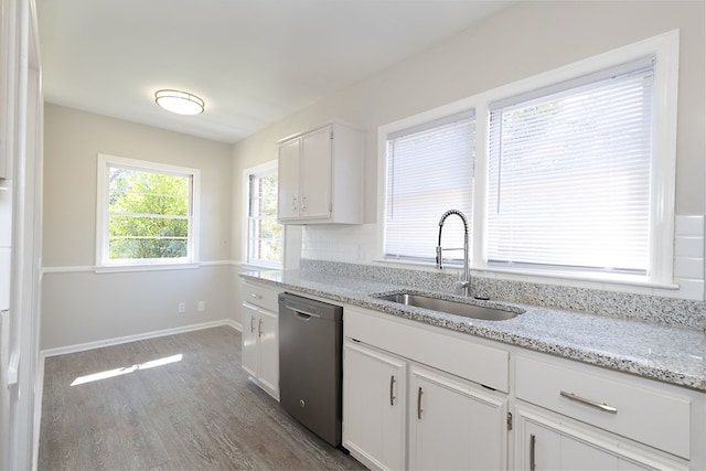 kitchen featuring dark wood finished floors, stainless steel dishwasher, white cabinetry, a sink, and light stone countertops