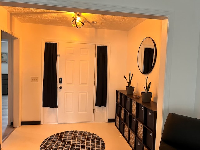 foyer featuring a textured ceiling