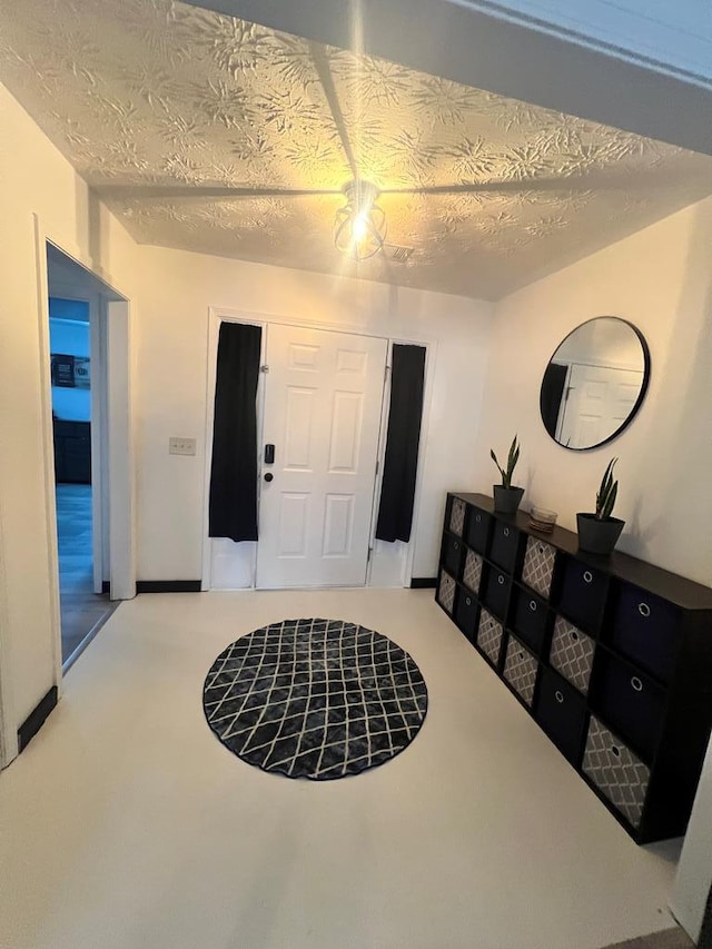 sitting room with carpet and a textured ceiling