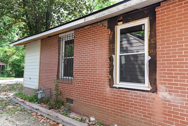 view of home's exterior featuring brick siding and crawl space
