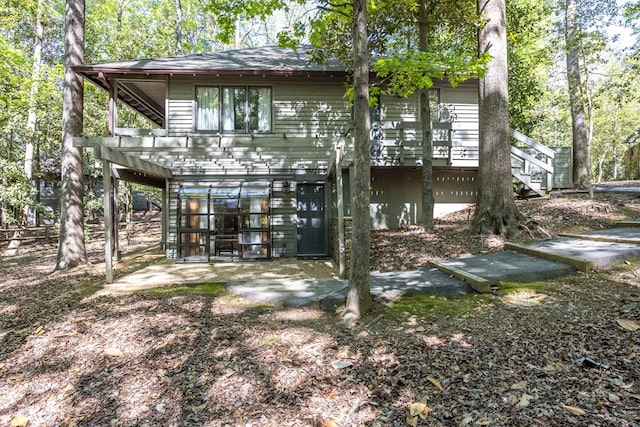 back of house with a patio and stairs