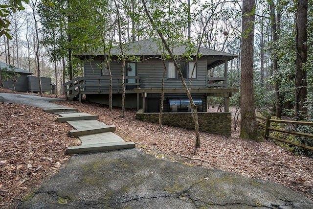 back of property featuring fence and roof with shingles