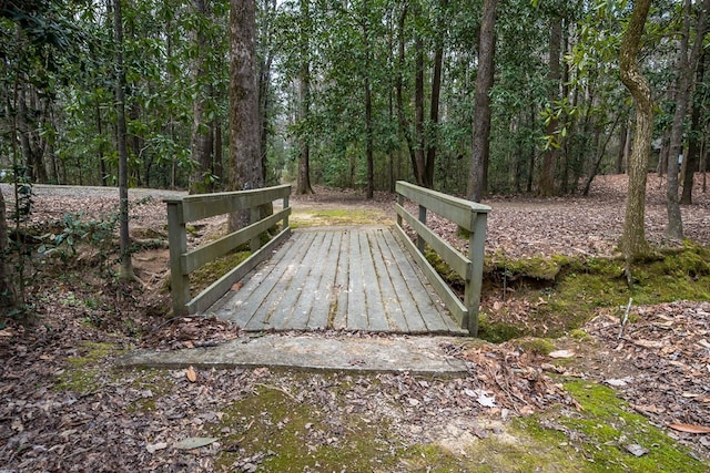 wooden terrace featuring a view of trees
