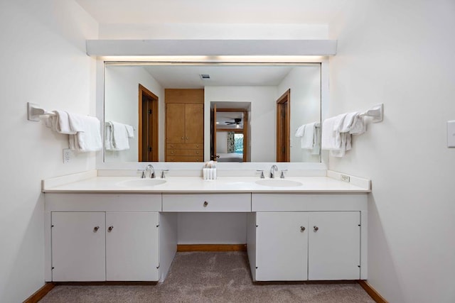 full bathroom featuring baseboards, visible vents, a sink, and double vanity