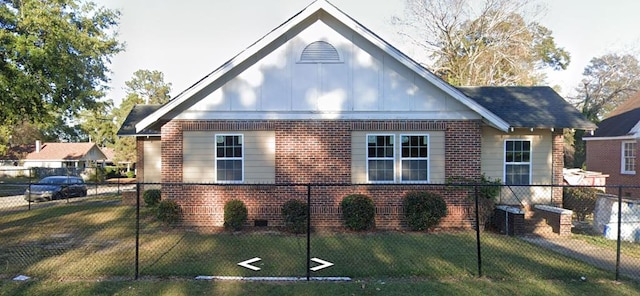 202 E Oak St, Tuskegee, AL 36083 - view of front of home with brick siding, a fenced backyard, and board and batten siding