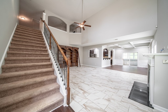 7312 Sorrel Ct, Columbus, GA 31909 - stairs featuring ceiling fan, marble finish floors, arched walkways, a towering ceiling, and baseboards