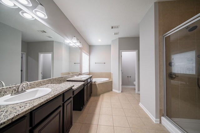 7312 Sorrel Ct, Columbus, GA 31909 - bathroom featuring a stall shower, tile patterned floors, a garden tub, baseboards, and toilet