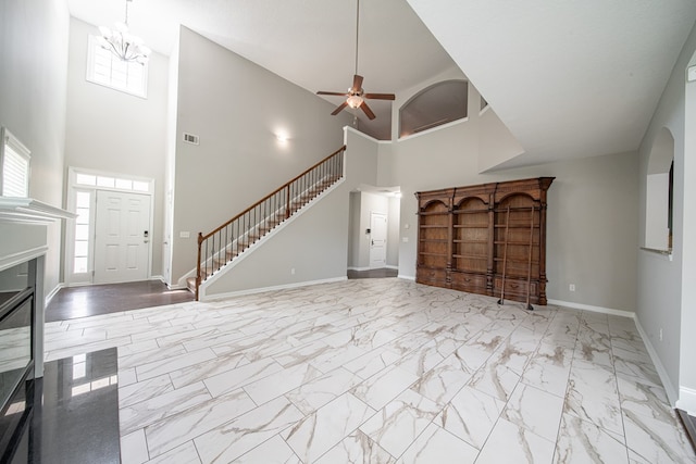 7312 Sorrel Ct, Columbus, GA 31909 - unfurnished living room with healthy amount of natural light, stairs, a towering ceiling, baseboards, and marble look tile flooring