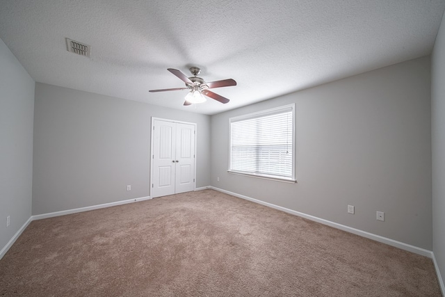 7312 Sorrel Ct, Columbus, GA 31909 - unfurnished bedroom with carpet flooring, a closet, baseboards, a ceiling fan, and a textured ceiling