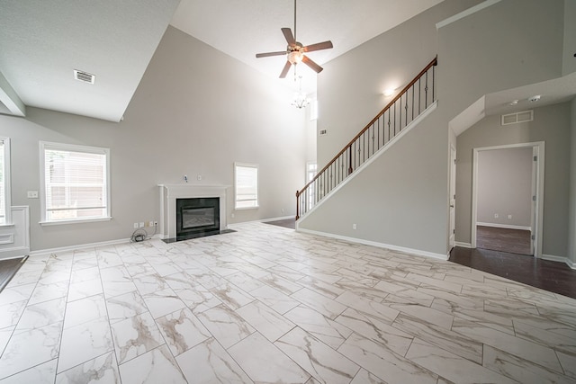 7312 Sorrel Ct, Columbus, GA 31909 - unfurnished living room featuring high vaulted ceiling, marble look tiles, a ceiling fan, a fireplace with flush hearth, and baseboards