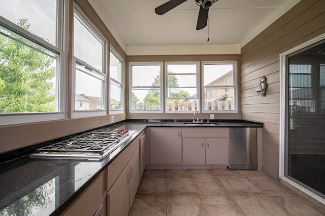 7312 Sorrel Ct, Columbus, GA 31909 - kitchen featuring a sink, plenty of natural light, stainless steel gas cooktop, wood walls, and ceiling fan