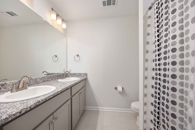 bathroom featuring toilet, vanity, tile patterned floors, and curtained shower