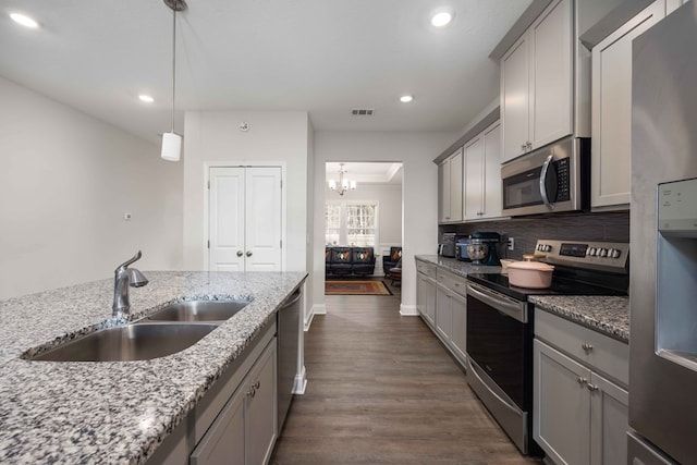 kitchen featuring gray cabinets, sink, light stone counters, and stainless steel appliances