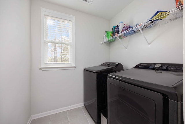 washroom featuring separate washer and dryer and light tile patterned flooring