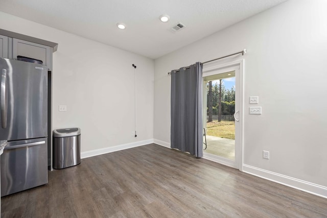 empty room with dark hardwood / wood-style flooring