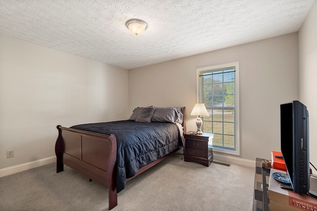 carpeted bedroom with a textured ceiling