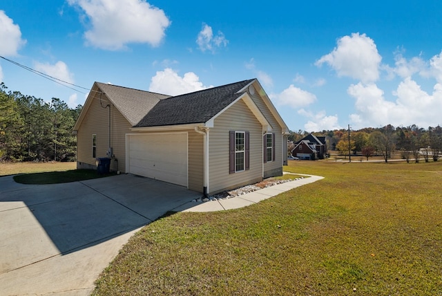 view of side of home featuring a garage and a yard