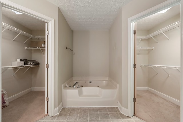 bathroom featuring a washtub and a textured ceiling